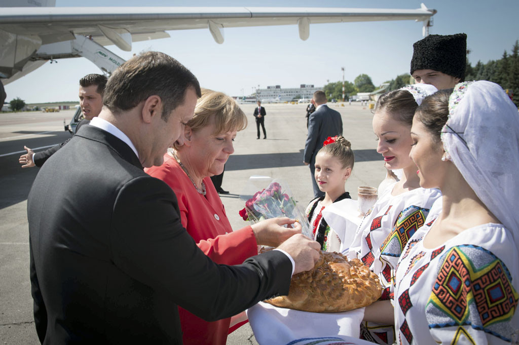 Young women in traditional costume present the Chancellor with bread.