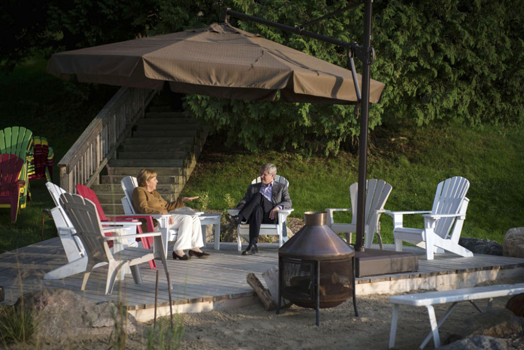 Angela Merkel and Stephen Harper talk on the patio of the Canadian Prime Minister's summer residence on Lake Harrington.