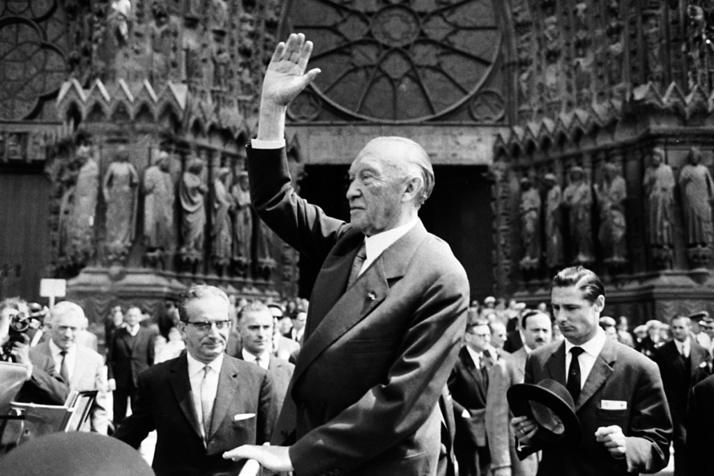 Federal Chancellor Konrad Adenauer waves to the crowd in front of Reims Cathedral on 8 July 1962.