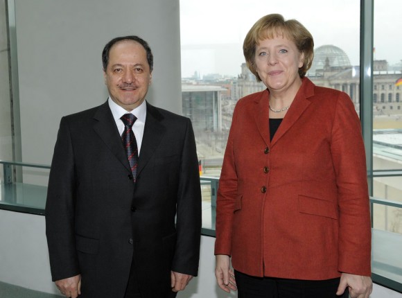 Chancellor Angela Merkel and Masoud Barzania, President of the Kurdistan Region, Iraq stand in front of a window at the Federal Chancellery.