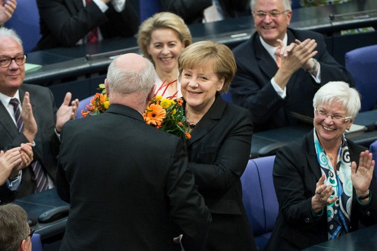 Angela Merkel receiving a bouquet of flowers after being re-elected Chancellor