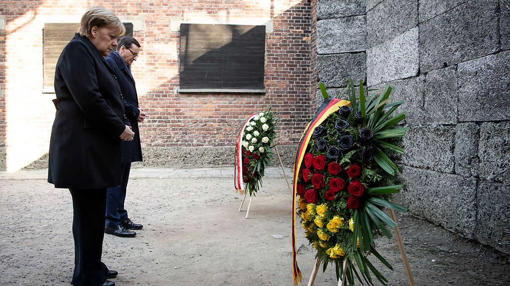 Chancellor Angela Merkel lays a wreath in the former German concentration camp in Auschwitz.