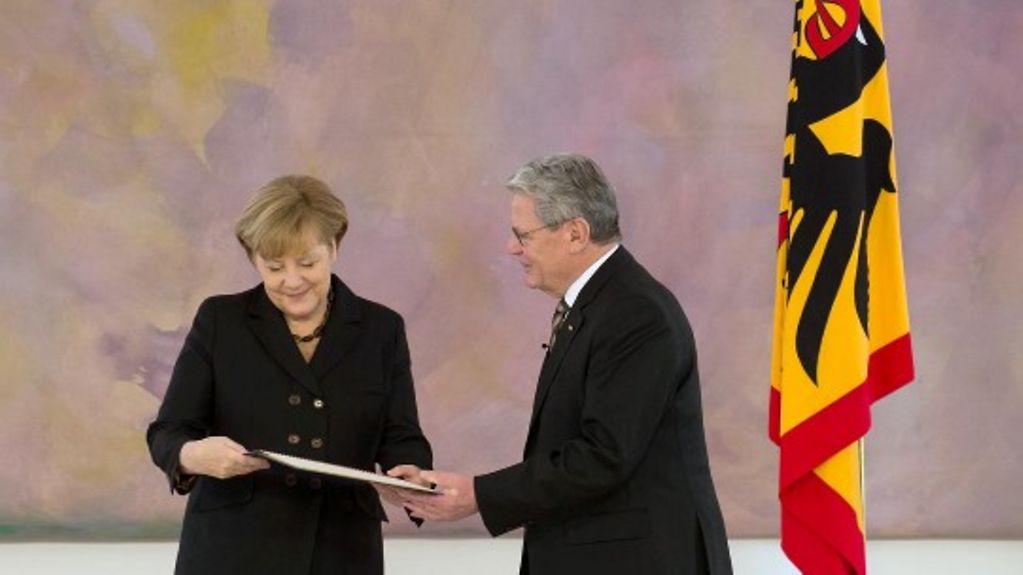 President Joachim Gauck presenting Chancellor Angela Merkel with her letter of appointment