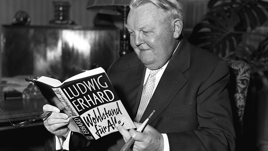 December 1957: Minister of Economics, Ludwig Erhard, the father of the "Economic Miracle" reading from his book "Prosperity for All"