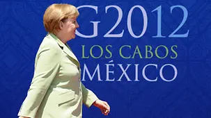 Chancellor Angela Merkel in front of the logo of the Mexican G20 summit
