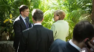 Angela Merkel and Steffen Seibert deep in discussion
