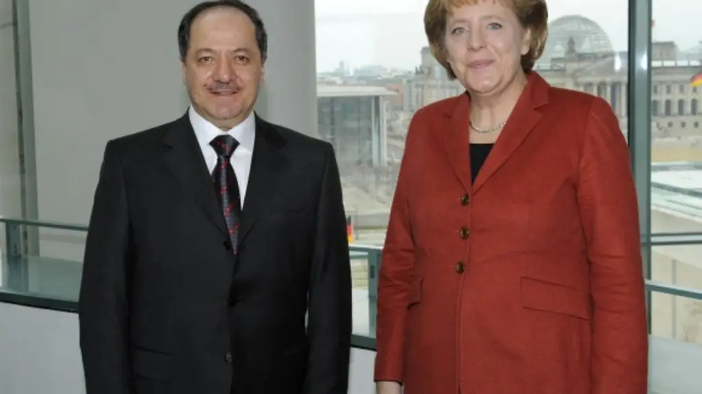 Chancellor Angela Merkel and Masoud Barzania, President of the Kurdistan Region, Iraq stand in front of a window at the Federal Chancellery.