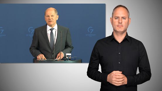Bundeskanzler Scholz und Gebärdensprach-Dolmetscher 