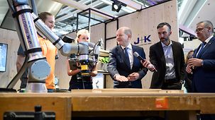 Federal Chancellor Olaf Scholz visiting the Universal Robots Germany GmbH stand at the International Crafts Fair.