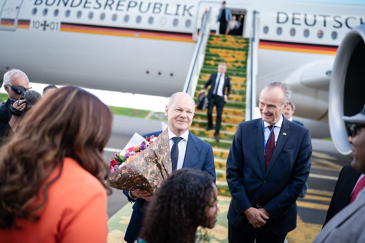 Bundeskanzler Olaf Scholz bekommt bei seiner Ankunft in Äthipien einen Blumenstrauß.