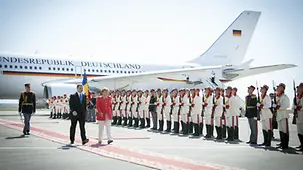 Angela Merkel and Vladimir Filat inspect the guard of honour.