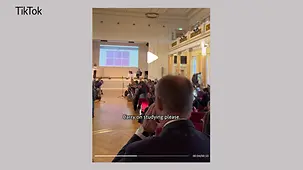 Bundeskanzler Merz betritt einen Hörsaal mit Studierenden