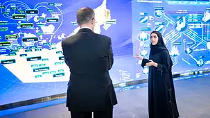 The photo shows Federal Chancellor Friedrich Merz in a conversation during his visit to ADNOC.