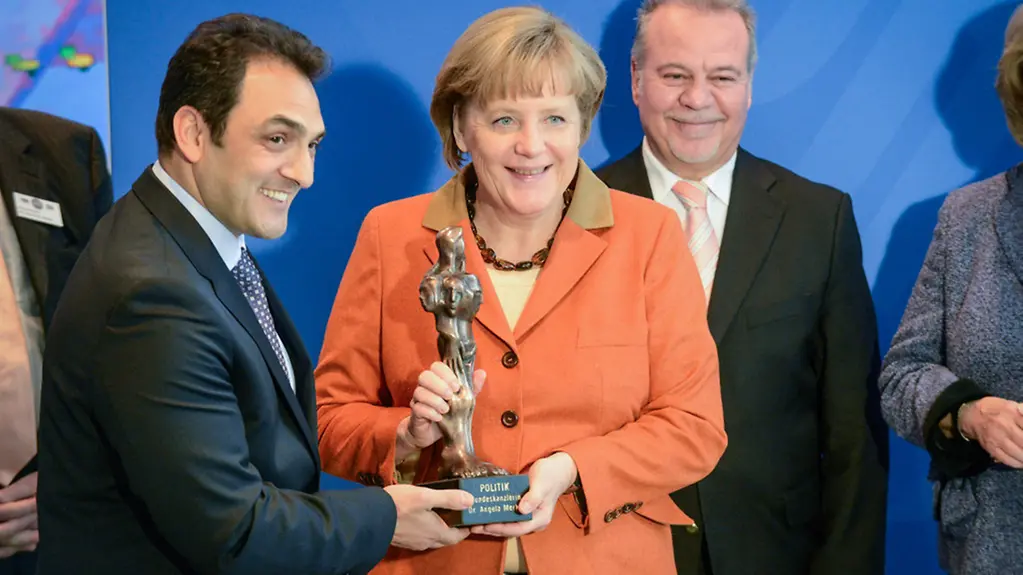 The award is presented to Chancellor Angela Merkel.