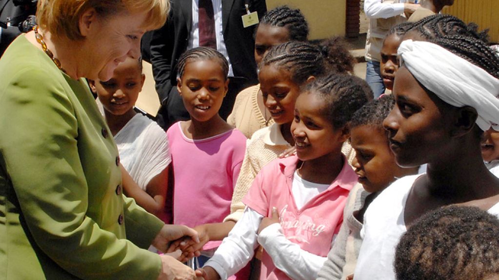Chancellor Angela Merkel with African girls