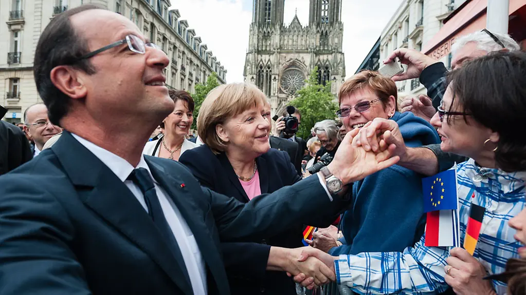 Merkel and Hollande mingle with the crowd