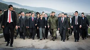 Chancellor Angela Merkel is accompanied by the Turkish Defence Minister Ismet Yilmaz and Colonel Ellerman as she goes to inspect a Patriot System.
