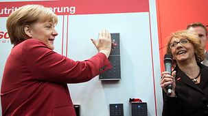 Angela Merkel, hand on the scanner